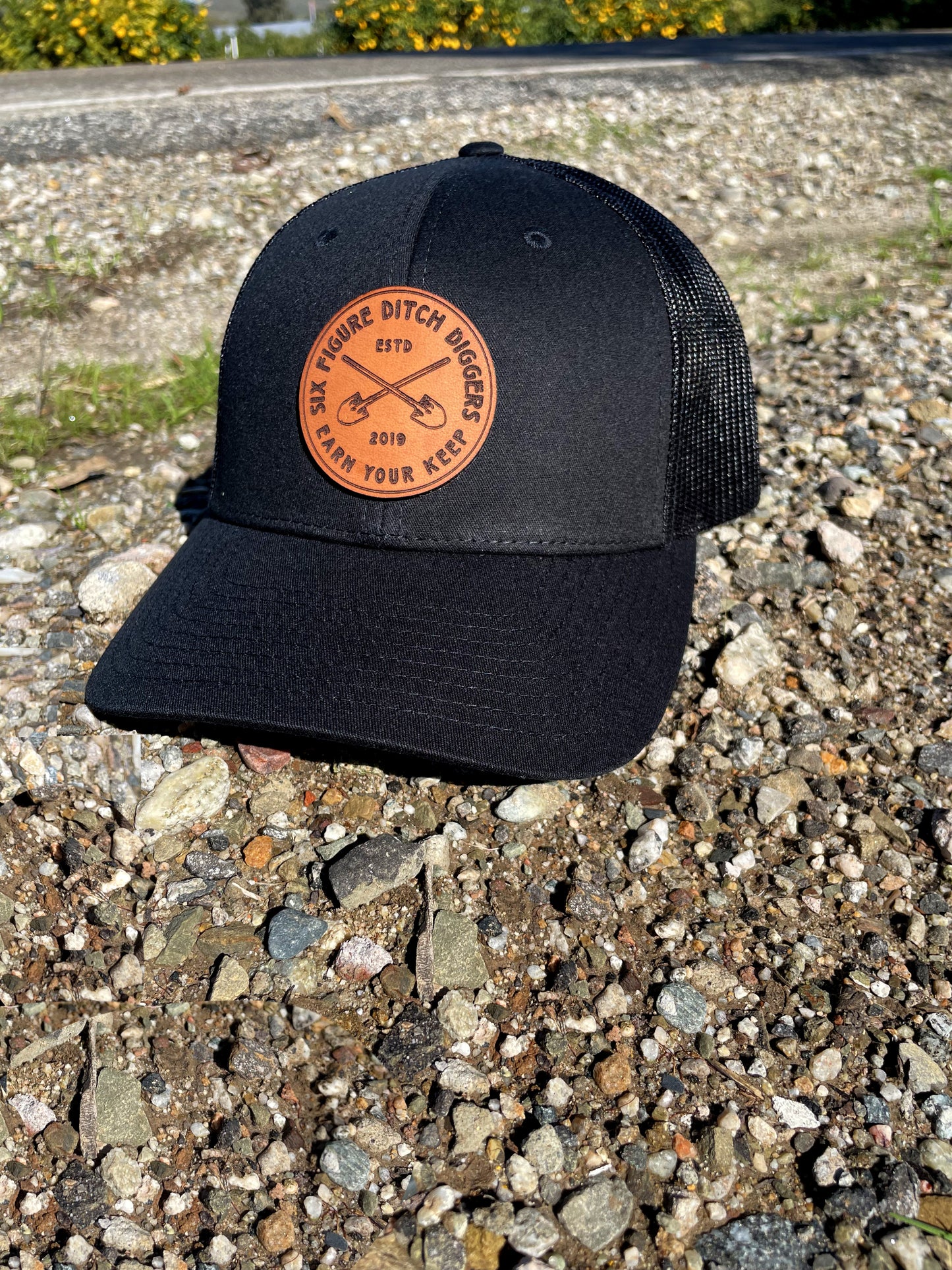 "Earn Your Keep" Leather Patch Trucker Hat