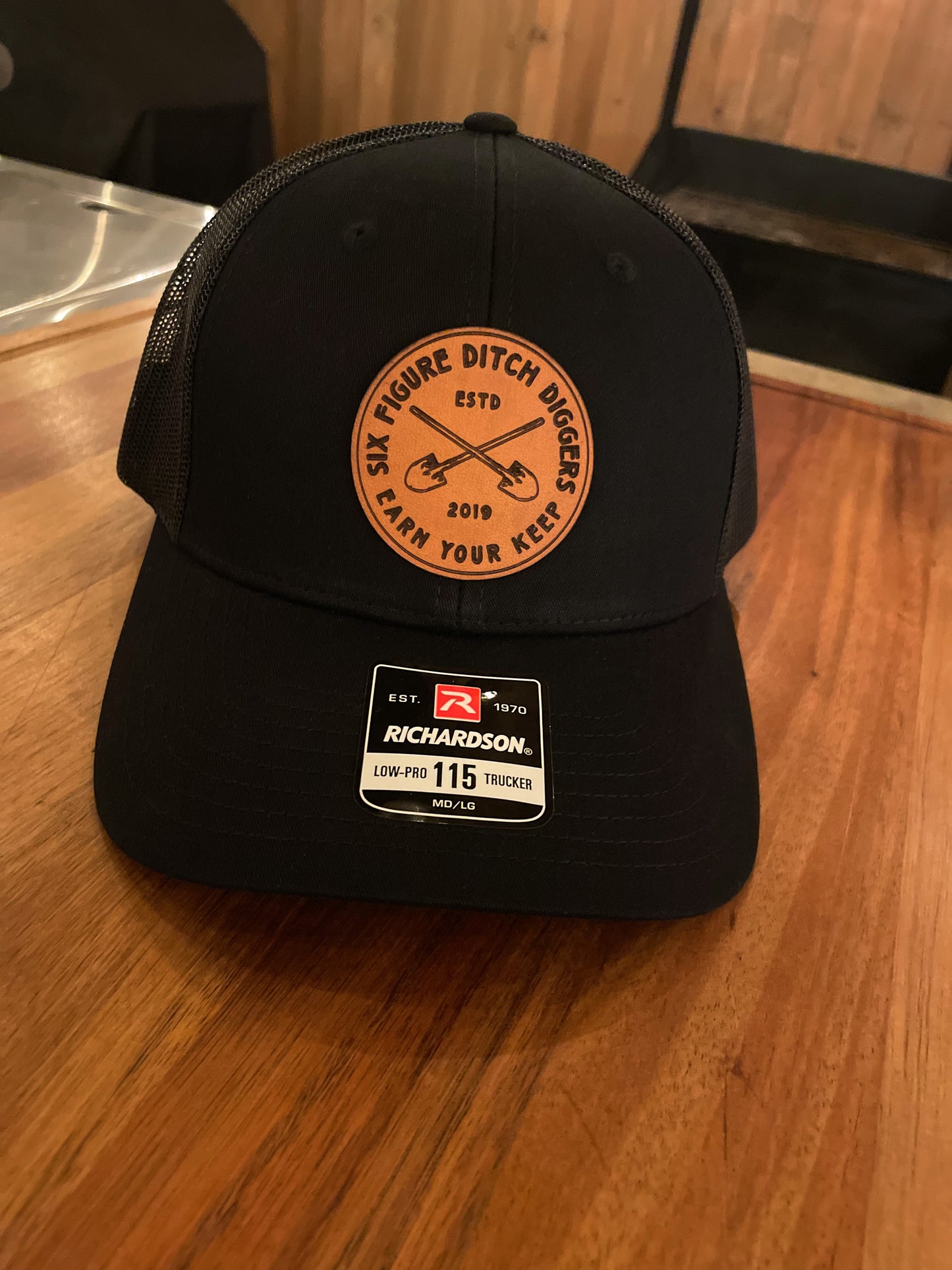 "Earn Your Keep" Leather Patch Trucker Hat