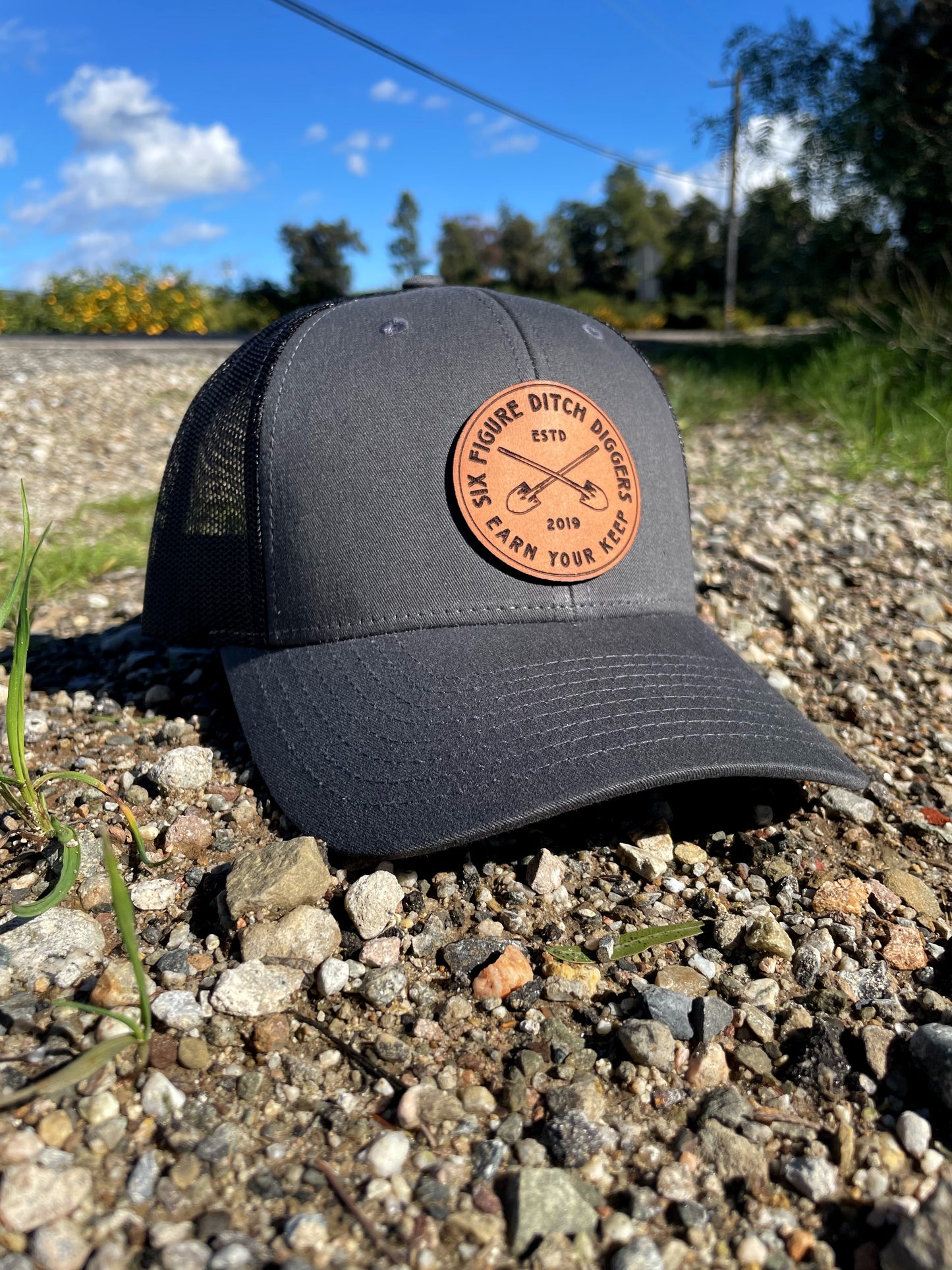 "Earn Your Keep" Leather Patch Trucker Hat