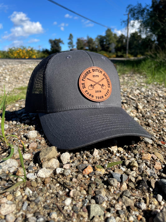 "Earn Your Keep" Leather Patch Trucker Hat